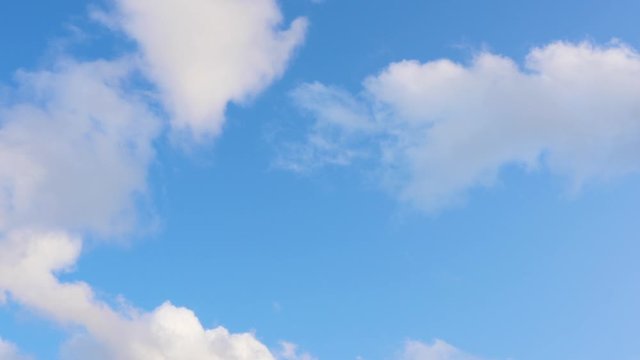 White clouds floating in the blue sky. Time-lapse