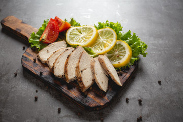 Grilled chicken on a cutting board.