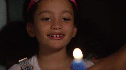Birthday girl blows a number 9 candle out for her 9th birthday - Powered by Adobe