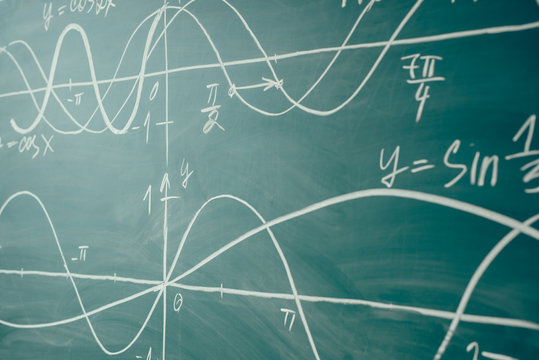 School math lesson. Trigonometry. Chalkboard Function graphs.