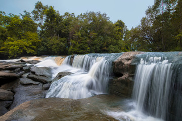 Waterfalls in tropical forests, Water from the creek flows onto the rocks, Cause a beautiful waterfall.