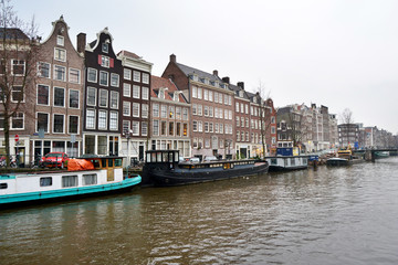 Naklejka premium View on the crooked houses of Amsterdam from a canal, Netherlands