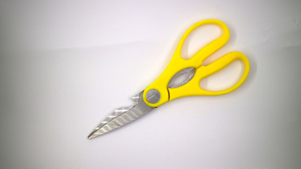 big yellow scissors on white background