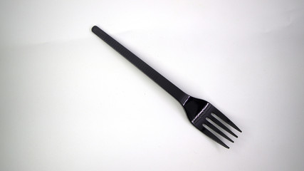black plastic fork isolated on white background