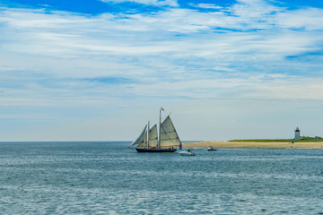 Naklejka premium wo-masted yacht and Beautiful landscape of ocean beach Cape cod Massachusetts