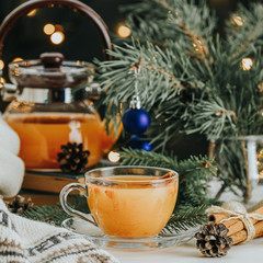 Christmas and New Year composition. Cup and teapot of hot spicy tea with sea buckthorn