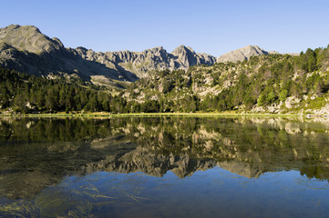 Naklejka na ściany i meble Reflections in a high mountain lake.