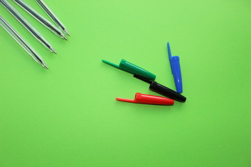 Colorful items for school, office on a green background.