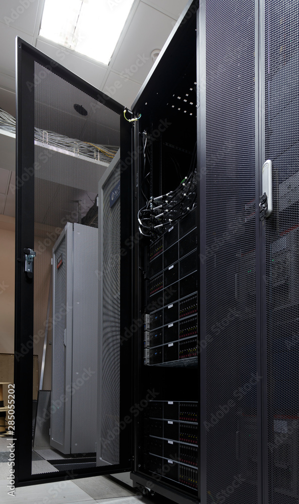 Poster server rack in big data center inside close up. supercomputer with hardware, storage blades, cables 