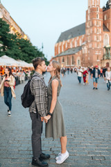 Fototapeta premium Young loving couple hugs at central square in Krakow (Cracow).