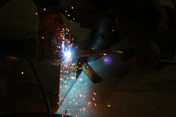 worker welding in workshop and welding