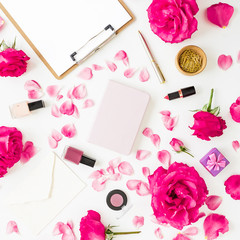 Obraz na płótnie Canvas Workspace with clipboard, pastel roses, cosmetics and accessories on white background. Flat lay, top view