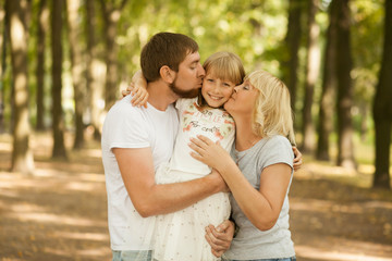 Three generation - grandmother, father, and little daughter. Family and people concept - happy excited smiling family at park outdoors