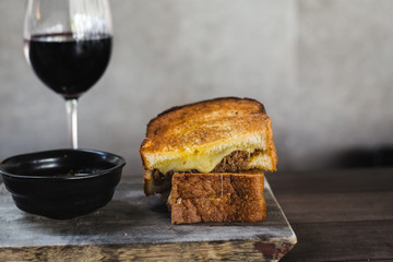 Braised Shortrib Grilled Cheese.  A blend of gruyere and taleggio cheese sandwiched between buttery artisanal white loaves.  Stuffed with juicy, braised beef shortrib.