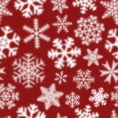 Naklejka na ściany i meble Christmas seamless pattern of white defocused snowflakes on red background