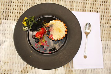 Dessert from a flour basket filled with mashed cottage cheese and berrys
