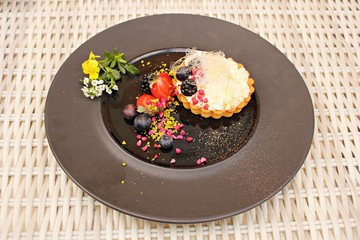 Dessert from a flour basket filled with mashed cottage cheese and berrys