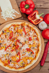 Pizza and red wine on wooden table background. Top view with copy space