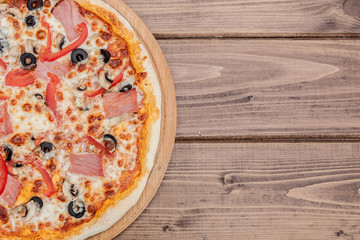 Pizza capricciosa traditional italian meal from prosciutto mushrooms artichokes egg parmesan olives.