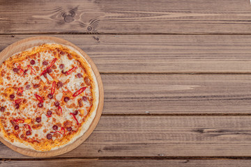 Pizza Restaurant Menu - Delicious Spicy Pizza with Sausages and Chili Pepper. Pizza on Rustic Wooden Table with Ingredients