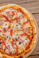 Pepperoni Pizza with Mozzarella cheese, Ham, Tomatoes, pepper, Spices . Italian pizza.