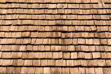 exposed wooden wall exterior, patchwork of raw wood forming a beautiful parquet wood pattern. rectangle wooden wall tile background(selected focus)