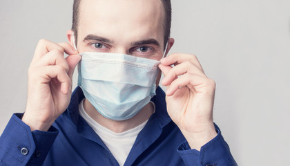 Happy young man a medical mask, portrait, copy space, close up, health care concept