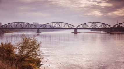 Fototapeta na wymiar Steel road and railway bridge on the Vistula River in Grudziadz in Poland