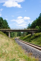 Fototapeta na wymiar railway tracks crossing green areas