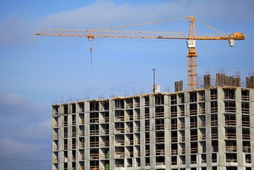 Crane and high-rise building. Construction site. The construction of modern apartment buildings