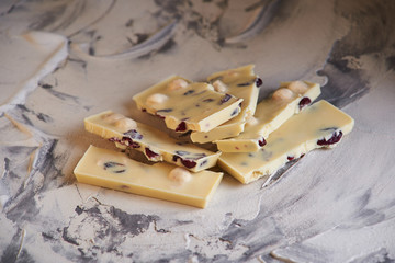 Pieces of dark and white chokolate on gray background