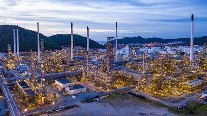 oil refinery and gas petrochemical industry with storage tanks steel  pipeline area at twilight aerial view from drone