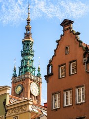 view of the clock tower of the main city hall of Gdańsk and the tenement house