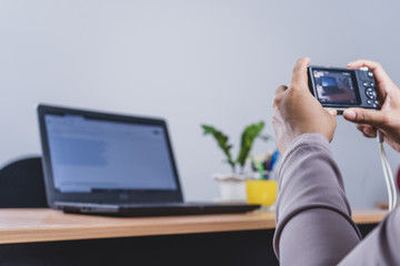 Woman photographer takes images with dslr camera