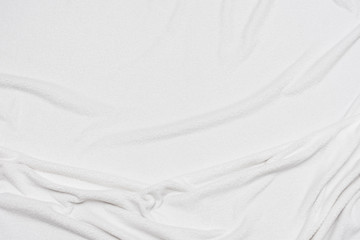 Fototapeta na wymiar White crumpled blanket, texture, top view
