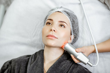 Woman during the oxygen mesotherapy procedure at the beauty salon, close-up view. Concept of a...