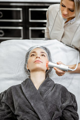 Female cosmetologist making oxygen mesotherapy to a woman at the luxury beauty salon. Concept of a...