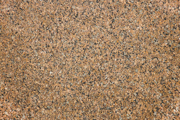 The background of polished granite in brown black shades. A background for design and creative work. Decoration and exterior decoration of the building. Construction works