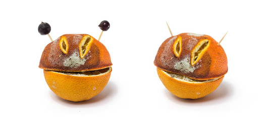 Two moldy cut oranges. Mocking smile. 