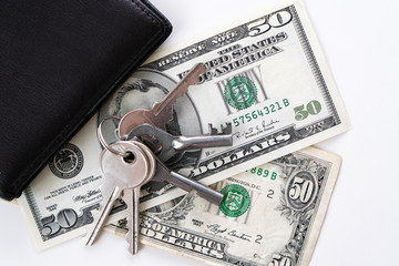 Two 50 dollars banknotes on a white background. Dollars with keys on a white background. Money in...