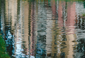 Blur reflection of house in a puddle after a rain. Textures and wallpapers