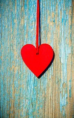 A symbol of love on blue wooden background 