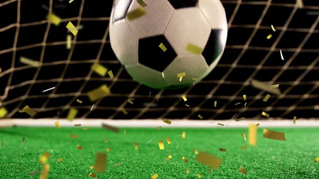 Football in front of a goal with confetti falling
