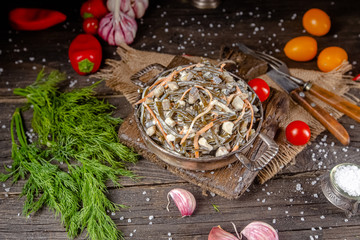 seaweed and carrot salad, mayonnaise sauce, in a rustic rustic bowl bowl, fork knife spoon, spices,...