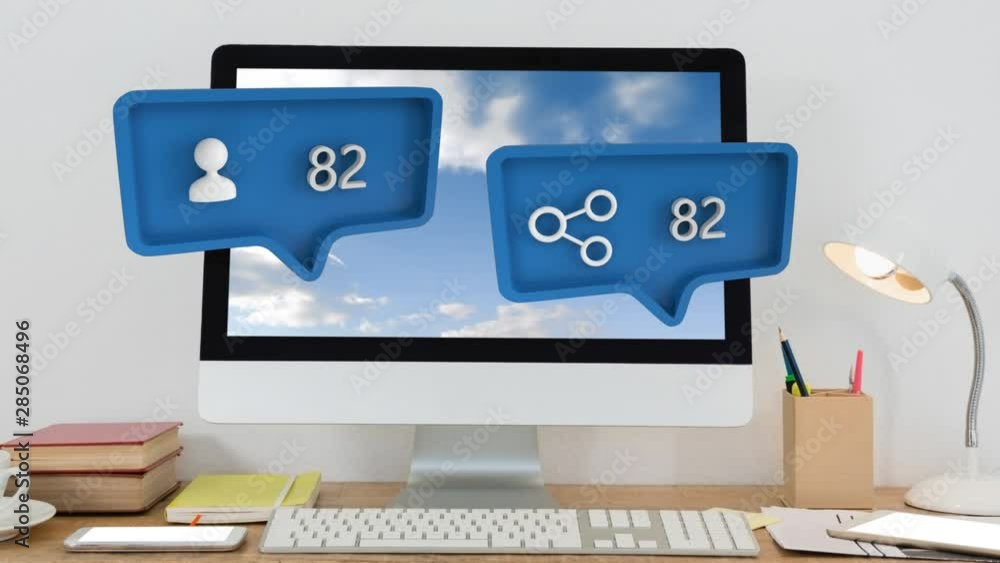 Poster share and person symbols and increasing numbers over computer, books, lamp on table