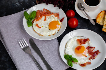 fried eggs with bacon and vegetables