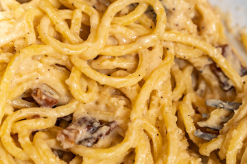 Bucatini carbonara, traditional Italian pasta dish from Rome made with eggs, cheese, bacon, and black pepper