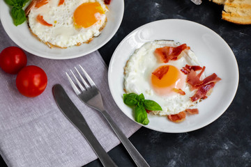 fried eggs with bacon and vegetables