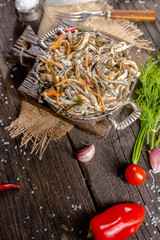 seaweed and carrot salad, mayonnaise sauce, in a rustic rustic bowl bowl, fork knife spoon, spices,...