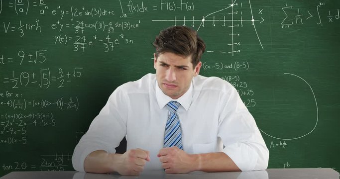 Man in front of moving maths on blackboard